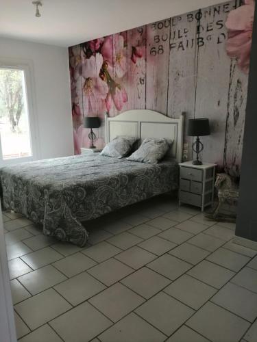 a bedroom with a bed and two tables and two lamps at La Margottière chez isa et titi in Rians