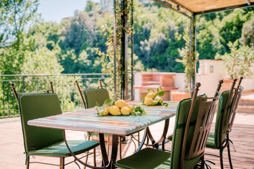 a table with chairs and fruit on a patio at Villa Sant'Alfonso in Scala