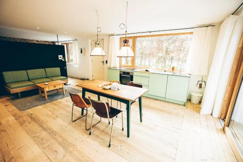 a kitchen and living room with a table and chairs at Ferienapartment Gasötz Berchtesgaden in Berchtesgaden