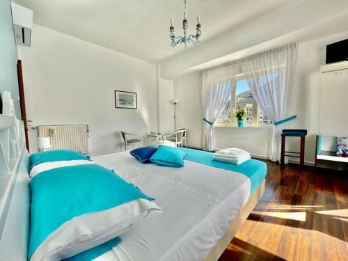 a bedroom with a large bed with blue pillows at B&B Tina in Piano di Sorrento