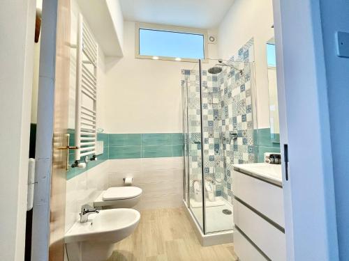 a bathroom with a toilet sink and a shower at B&B Tina in Piano di Sorrento