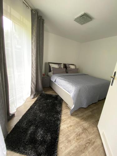 Кровать или кровати в номере Luxus Apartament