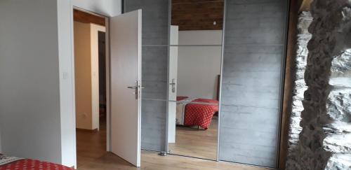 a mirrored door in a room with a bedroom at Le Montagnon in Laruns