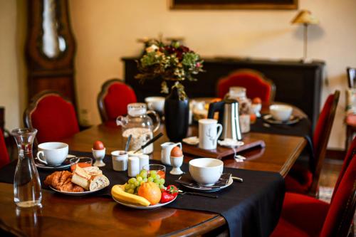 a table with breakfast foods on a table at Domaine de Monda in Argelès-Gazost