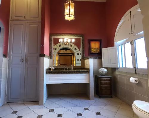 a bathroom with a sink and a mirror at La Perla Hotel Boutique B&B in Guadalajara