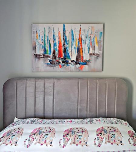 a bedroom with a bed with a painting on the wall at Home Mood Apart Hotel in Antalya
