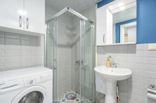 a bathroom with a washing machine and a sink at Home Mood Apart Hotel in Antalya