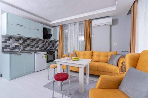a living room with a couch and a table at Home Mood Apart Hotel in Antalya
