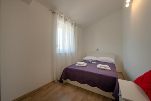 a bedroom with a bed with two towels on it at Villa Ester in Pula