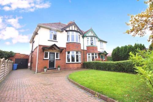 a large brick house with a brick driveway at Acacia Breezes - Delightful Scarborough Semi in Scarborough