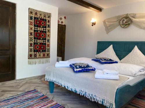 a bedroom with a bed with towels on it at Casa Soarelui in Murighiol