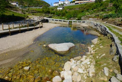 a large pool of water with rocks in it at Casa dos Alcaides in Sabugueiro