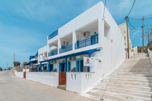 a white building with stairs in front of it at sunsetview1 studios in Batsi
