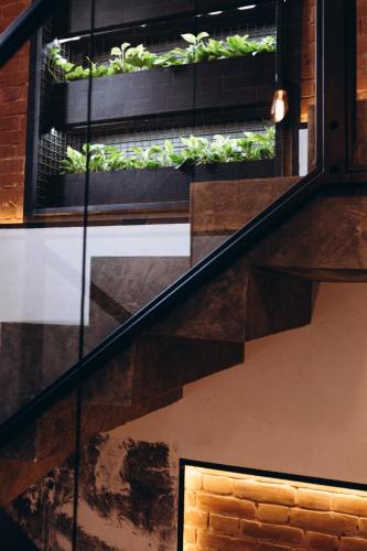 a staircase with a window with plants on it at Kulikovskiy hotel in Kharkiv