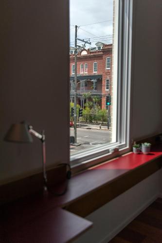an open window with a view of a street at Travelers New Orleans in New Orleans