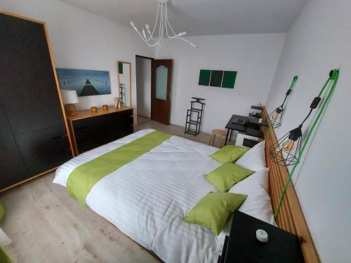 a bedroom with a large bed with green pillows at Relax Spiral House in Oradea