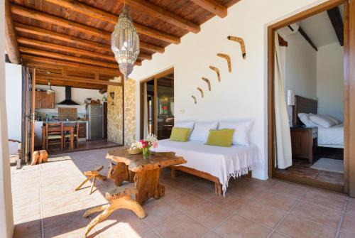 a bedroom with a bed and a table at Villa Can Sans in Cala San Vicente