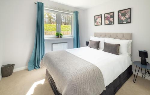 a bedroom with a large bed and a window at Lily Bank House in Inverness