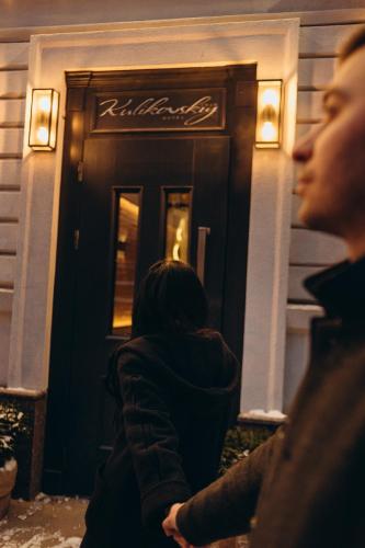 two women standing in front of a building at Kulikovskiy hotel in Kharkiv
