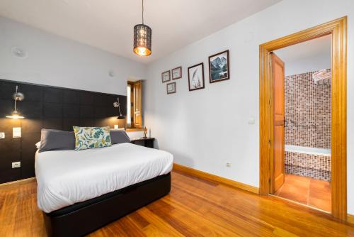 a bedroom with a bed and a large mirror at El Torreon de Navacerrada in Navacerrada