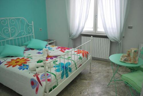 a small bedroom with a bed and a table at Casa Torrese in Torre del Greco