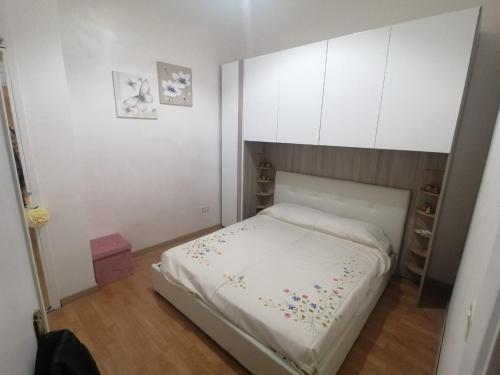 a small bedroom with a white bed and cabinets at Casa Stella in Castel di Sangro