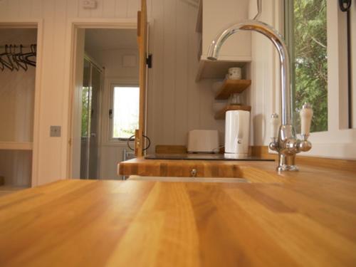 a kitchen with a wooden counter top and a sink at Wolstonbury Getaway in Hassocks