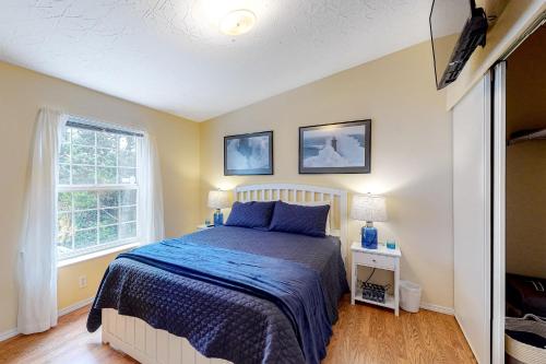 a bedroom with a bed and a window at Lighthouse View in Lincoln City