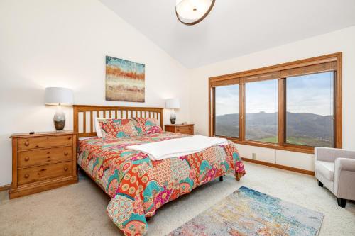 a bedroom with a bed and a window and a chair at Fox Run Retreat in Banner Elk