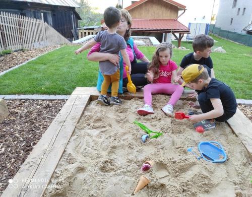 a group of children playing in the sand at Chata Matzo in Mýto pod Ďumbierom