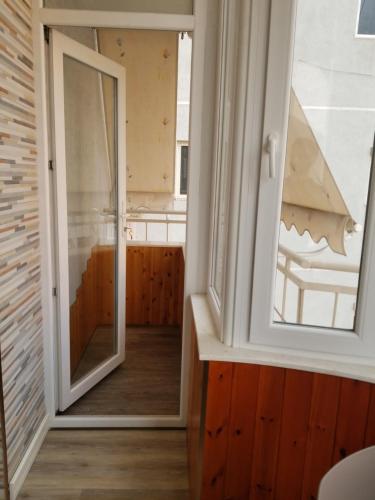 a room with a mirror and a window at Oro Apartments Tirana in Tirana