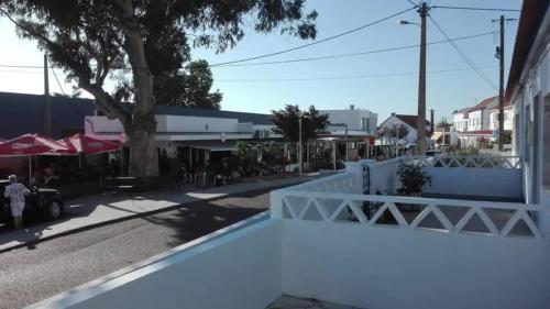 a view of a street with a white fence at Comporta Family House in Comporta
