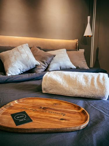 a bed with a wooden tray on top of it at B&B SALUS CIVICO 23 in Reggio Emilia