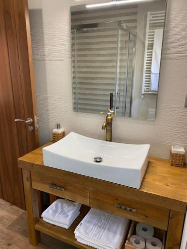 a bathroom with a white sink and a mirror at Apartamentos Numancia in Garray
