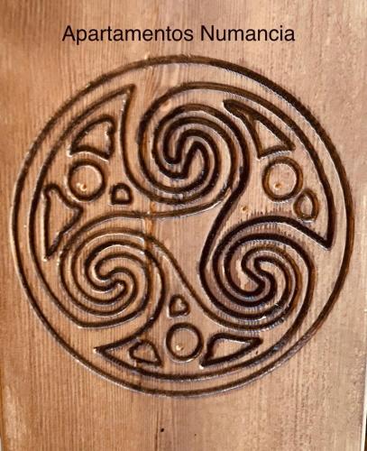 a picture of a wood cutting board with aorenimoimoemeteryemetery at Apartamentos Numancia in Garray