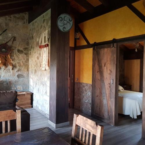 a bedroom with a bed and a wooden door at Apartamentos Numancia in Garray