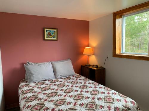Voodi või voodid majutusasutuse L'Auberge Refuge du Trappeur toas