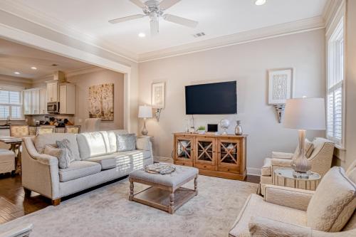 a living room with a couch and a tv at Price Street Place in Savannah