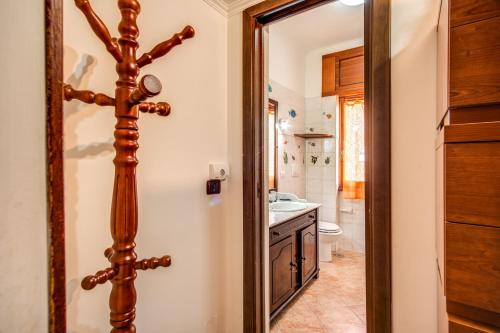 a bathroom with a wooden door leading into a bathroom with a sink at SWEET HOME LULLABY - free parking in Passoscuro