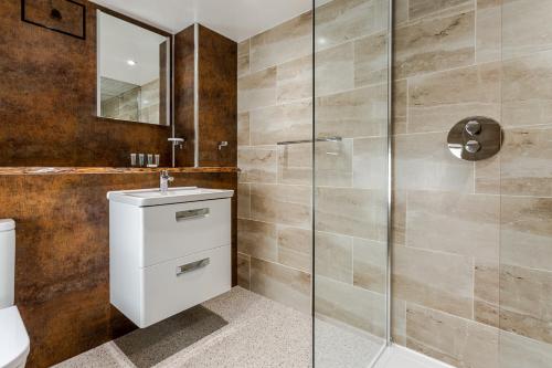 a bathroom with a sink and a shower at Bryn Goleu Bed & Breakfast in Llandudno
