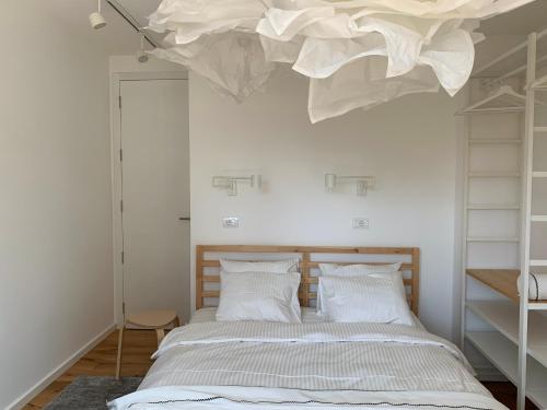 a bedroom with a bed with a chandelier above it at Apartment View in Užice