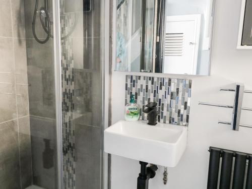 a bathroom with a sink and a shower at 9 Navigation Square in Skipton