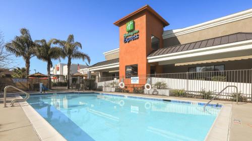 a large swimming pool in front of a hotel at Holiday Inn Express Lompoc, an IHG Hotel in Lompoc