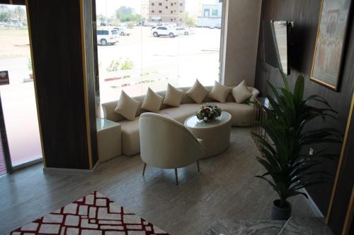 a living room with a couch and a table at AL MARSA HOTEL APARTMENTS in Khor Fakkan