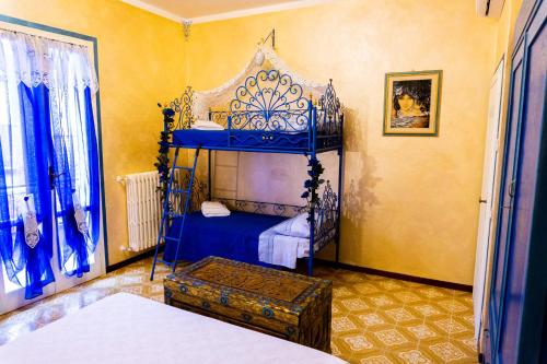 a bedroom with a blue canopy bed in a room at Bellavista Versilia in Pietrasanta