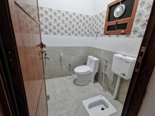 y baño con aseo y lavamanos. en Villa Salassel Al Jabal Al Akhdar فلة سلاسل الجبل الأخضر, en Al ‘Ayn