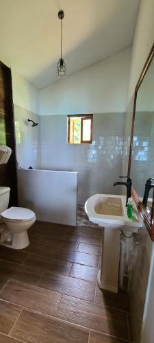 a bathroom with a tub and a toilet and a sink at Wilton House Oceanview Cabin in Mearnsville