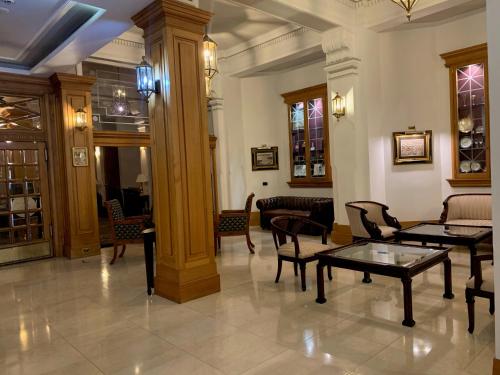a lobby with tables and chairs in a building at Castlereagh Boutique Hotel, an Ascend Collection Hotel in Sydney