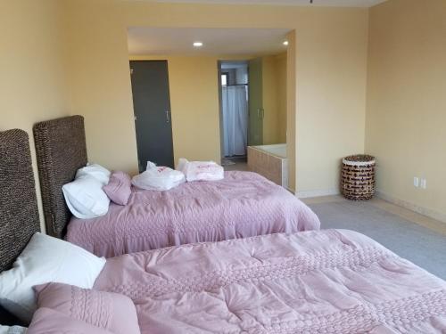 Postel nebo postele na pokoji v ubytování Condominio Paraiso