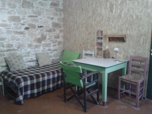 a room with a table and a table and chairs at Stoneworld in Évdhilos
